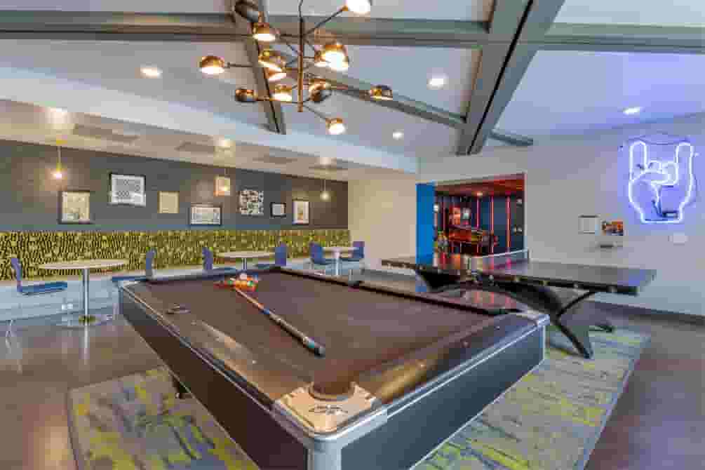Game Lounge with pool table and table tennis next to arcade room